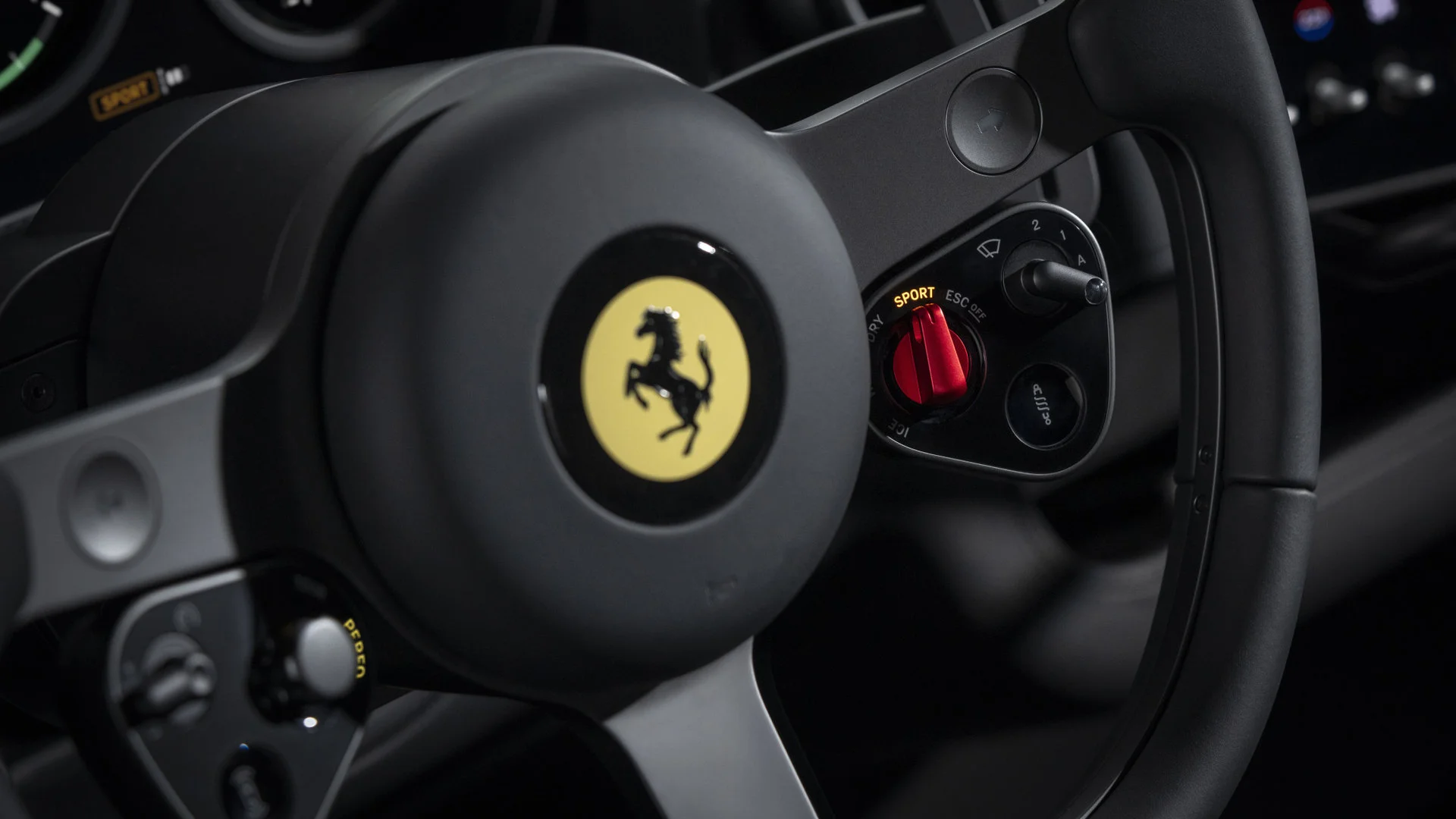 Frontal view of the Ferrari Luce steering wheel with dashboard behind showing digital speedometer reading 210 km/h, tachometer and G force meter with OLED panels and physical needles