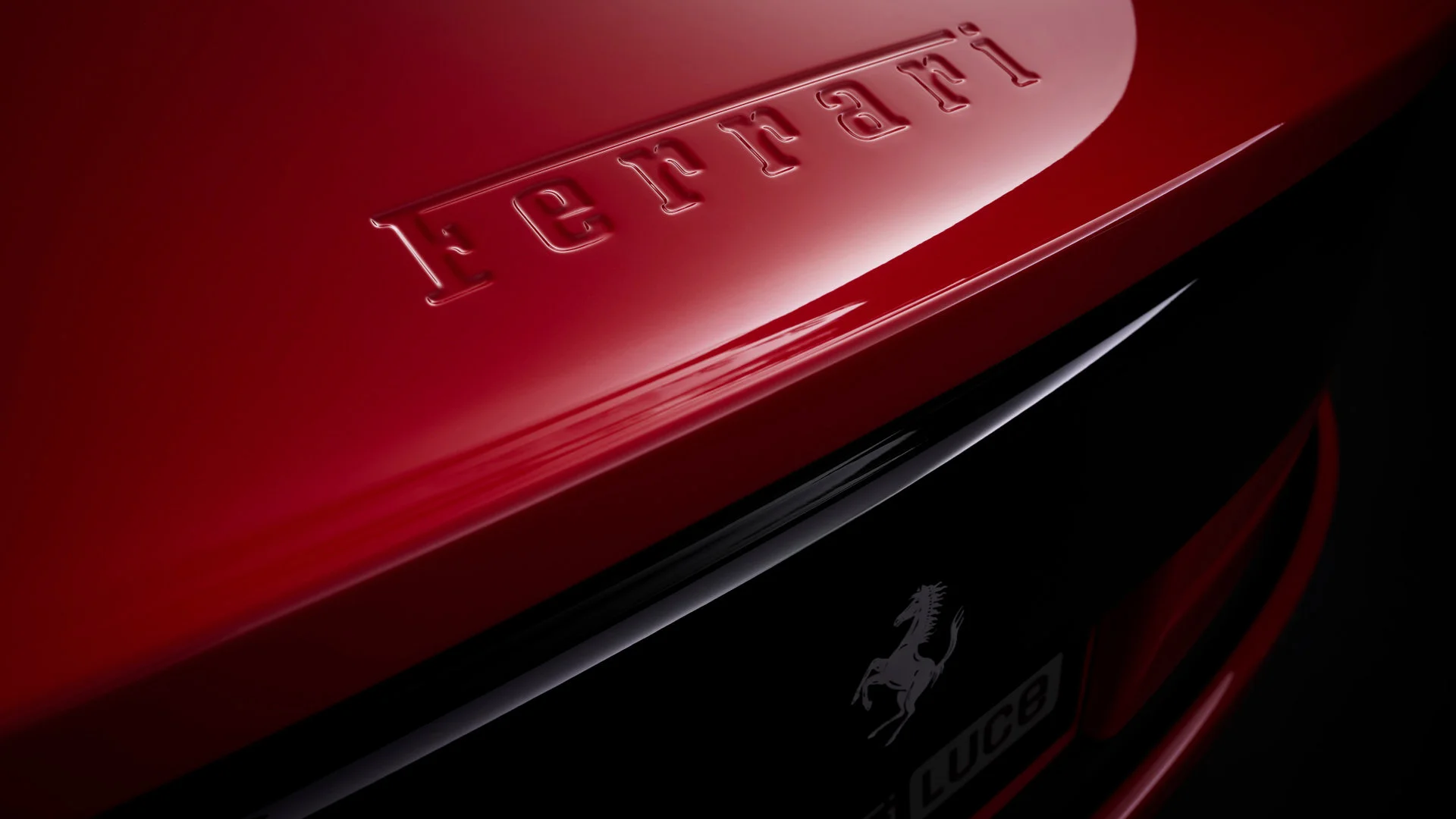 Detail of the Ferrari emblem embossed on the rear bodywork of the red Ferrari Luce, with the prancing horse and Luce inscription in black beneath