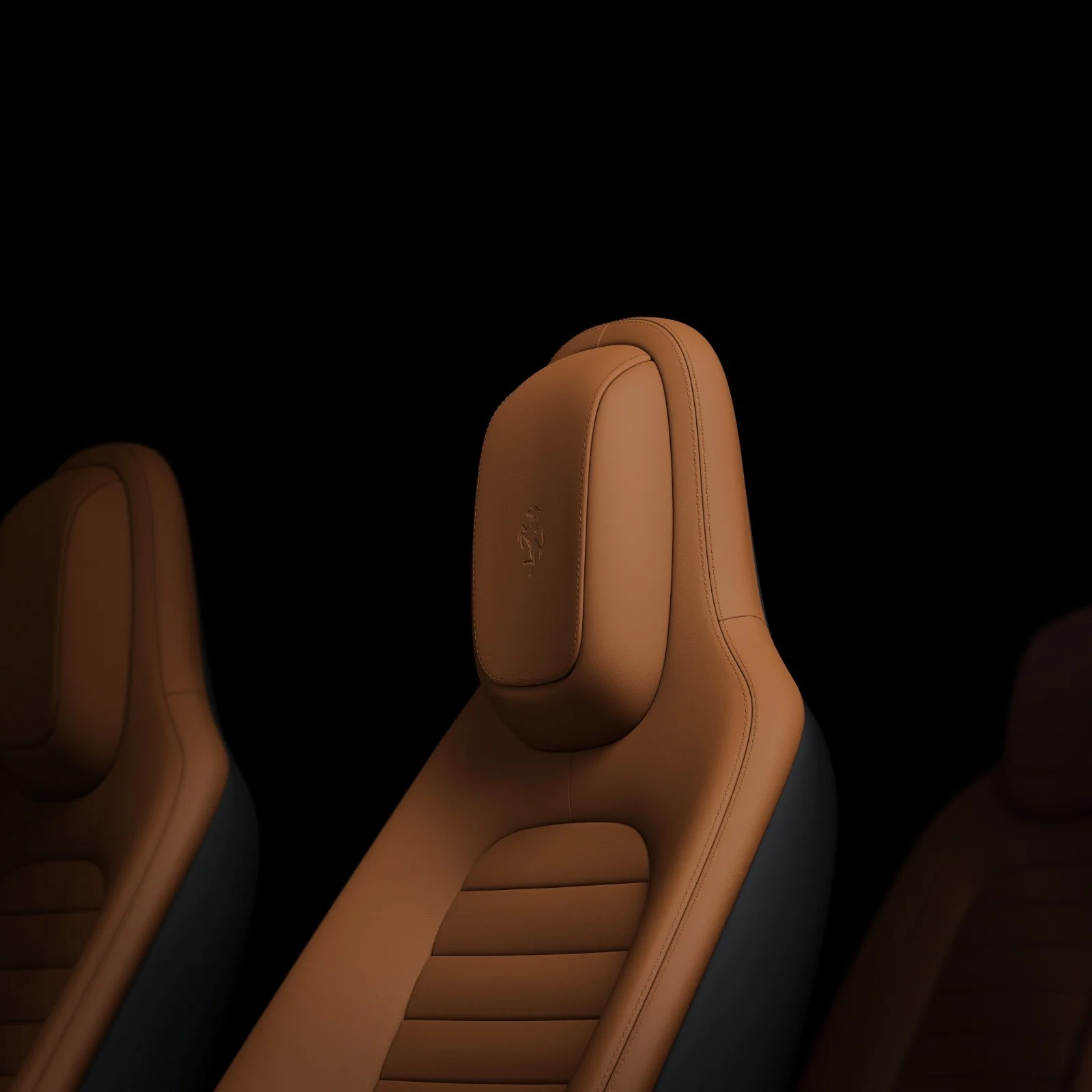 Detail of the front seats of the Ferrari Luce in tan beige leather with the prancing horse embroidered on the headrest