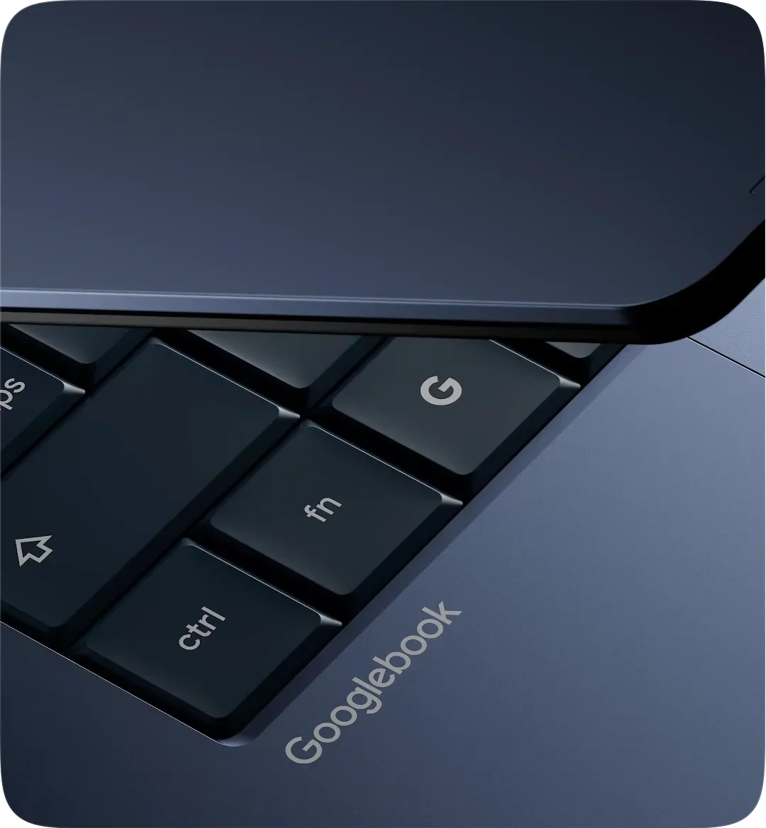 Detail of the Googlebook keyboard highlighting the G key and the Googlebook wordmark engraved on the dark blue chassis next to the ctrl and fn keys.
