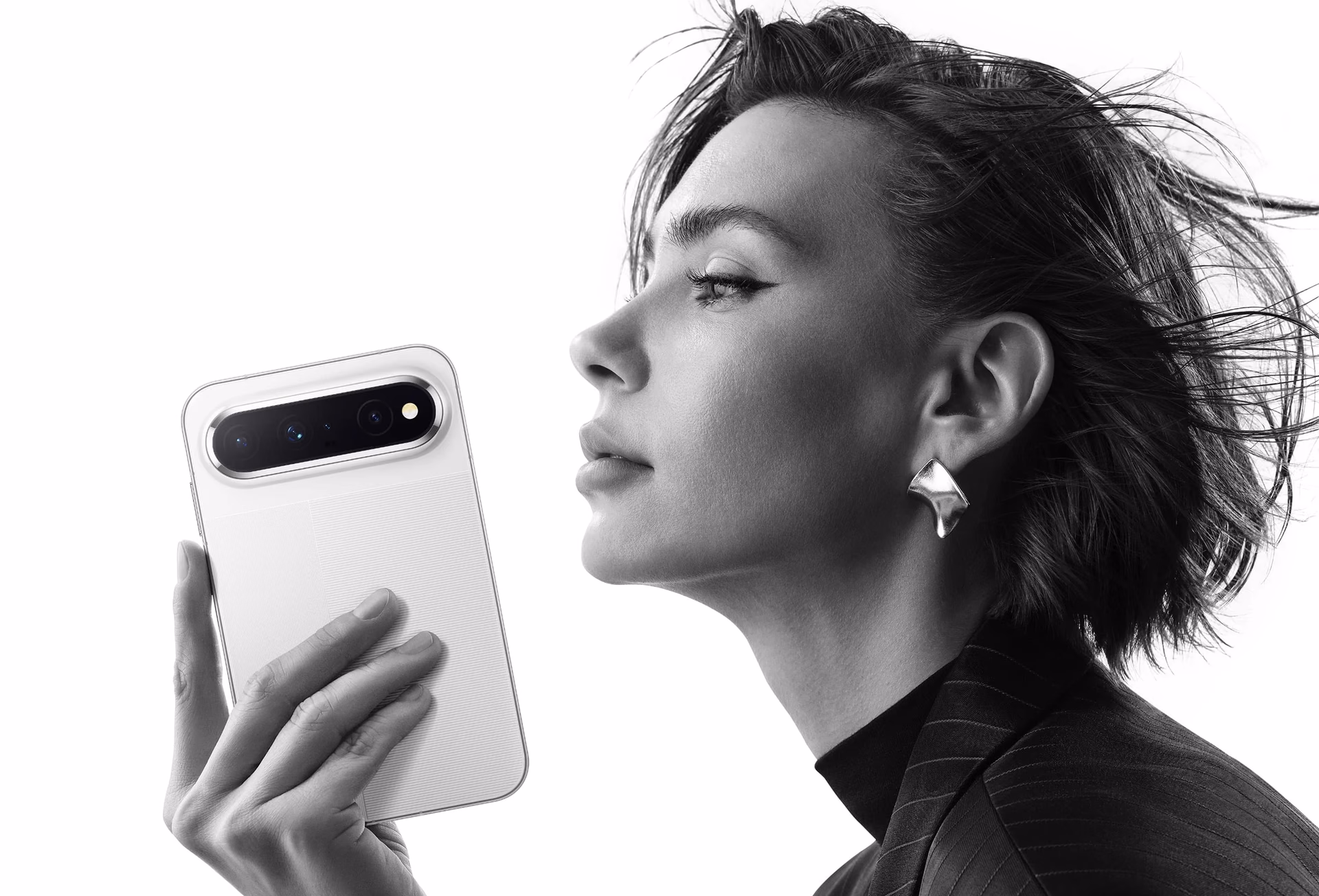 Side-profile model holding the Pura X View in white at face height