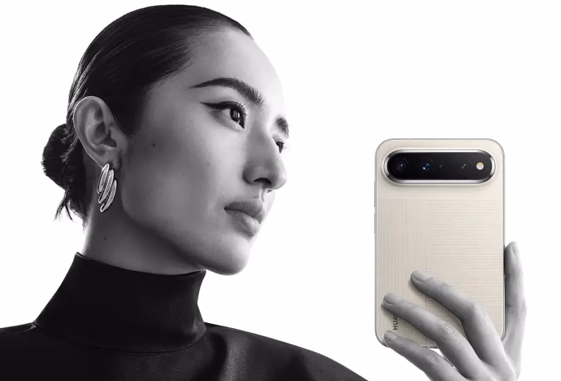 Model with a bun holding the Pura X View in linen gray with an open hand