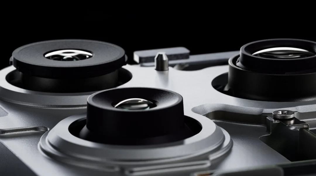 iPhone 18 Pro triple-camera module in silver, macro detail of the three lenses.
