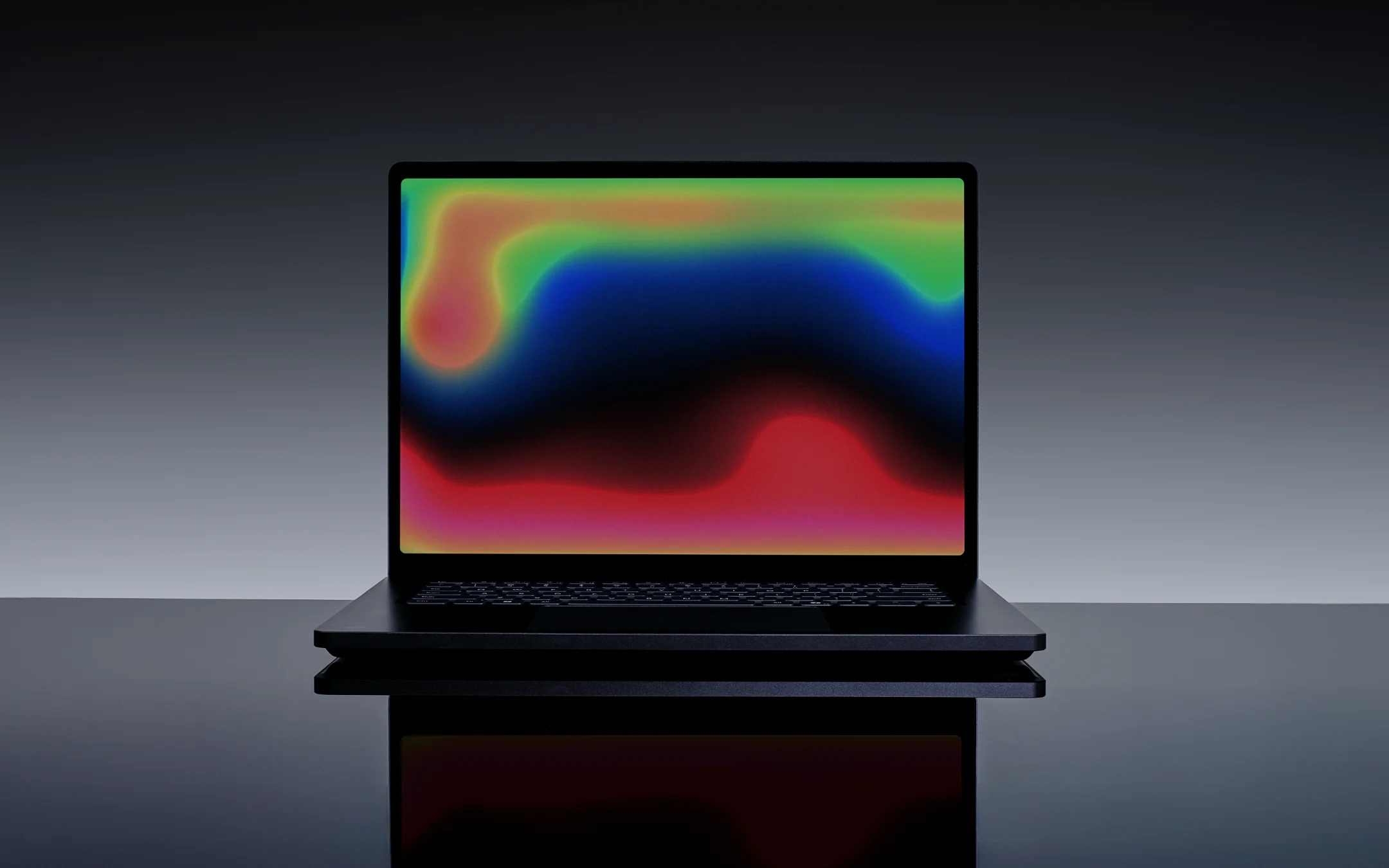 Surface Laptop Ultra displaying a saturated multiclored gradient highlighting the mini-LED panel's HDR brightness