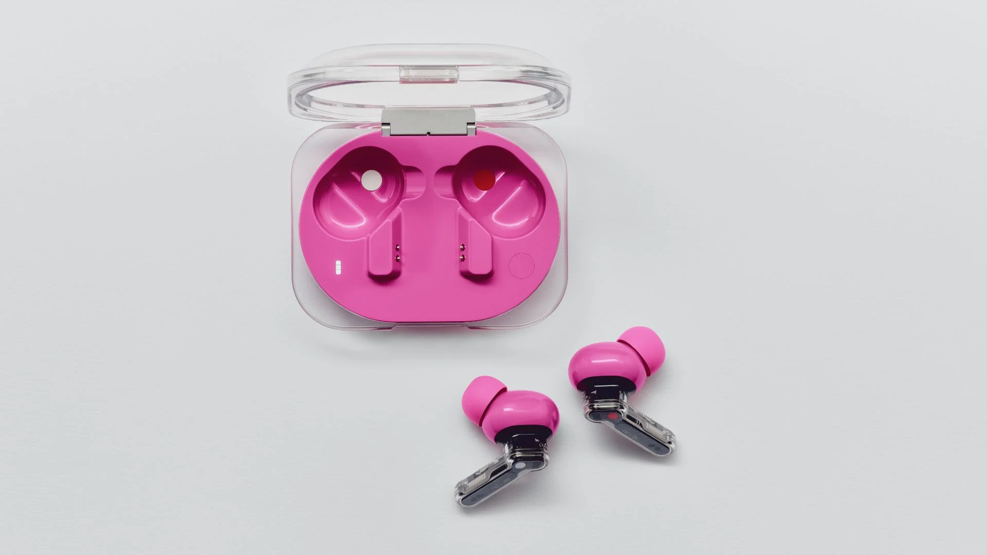Estuche rosa del Nothing Ear (3a) abierto con el par de auriculares apoyados al costado