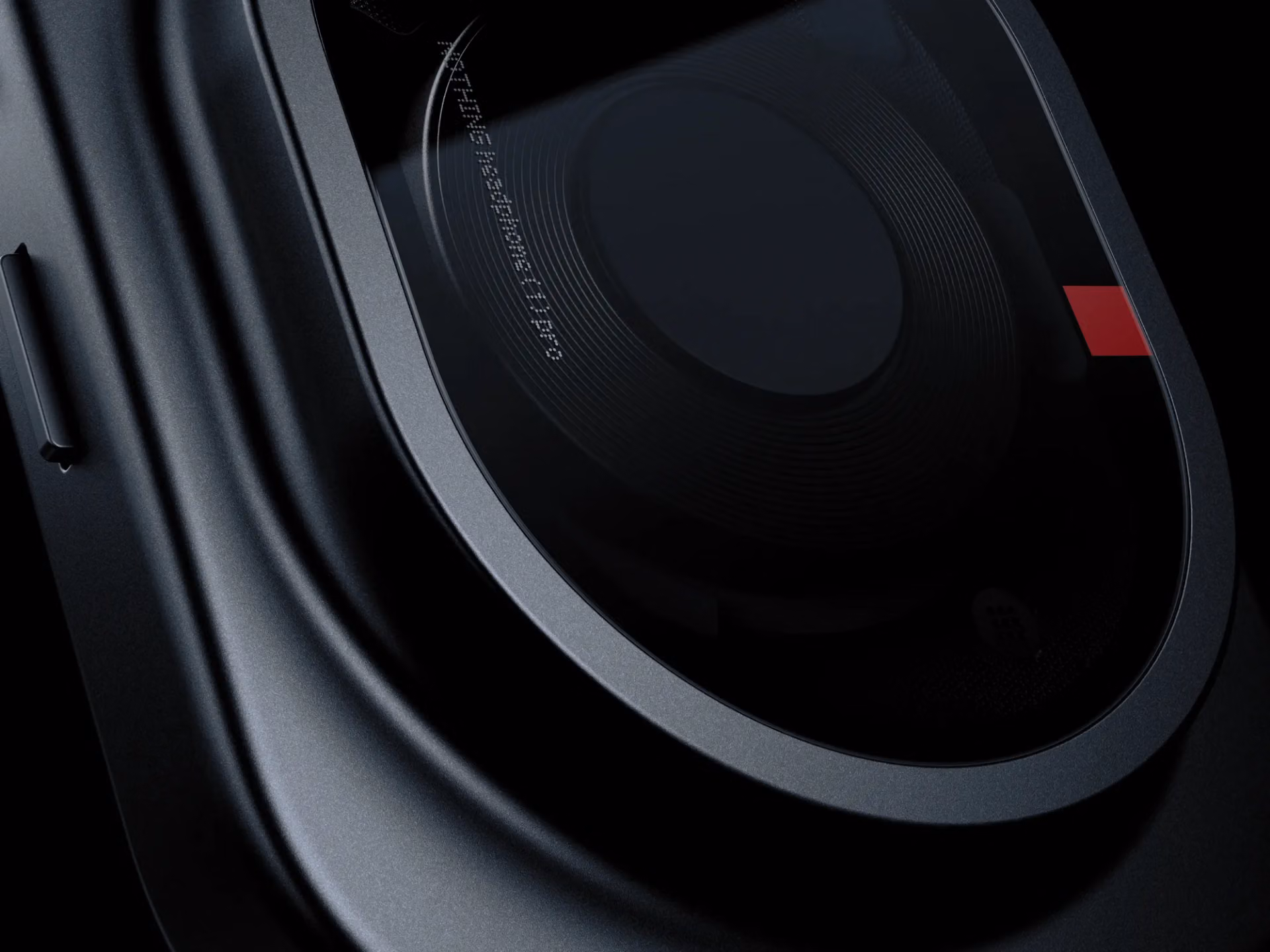 Glass over the black earcup with the model name engraved and a red detail