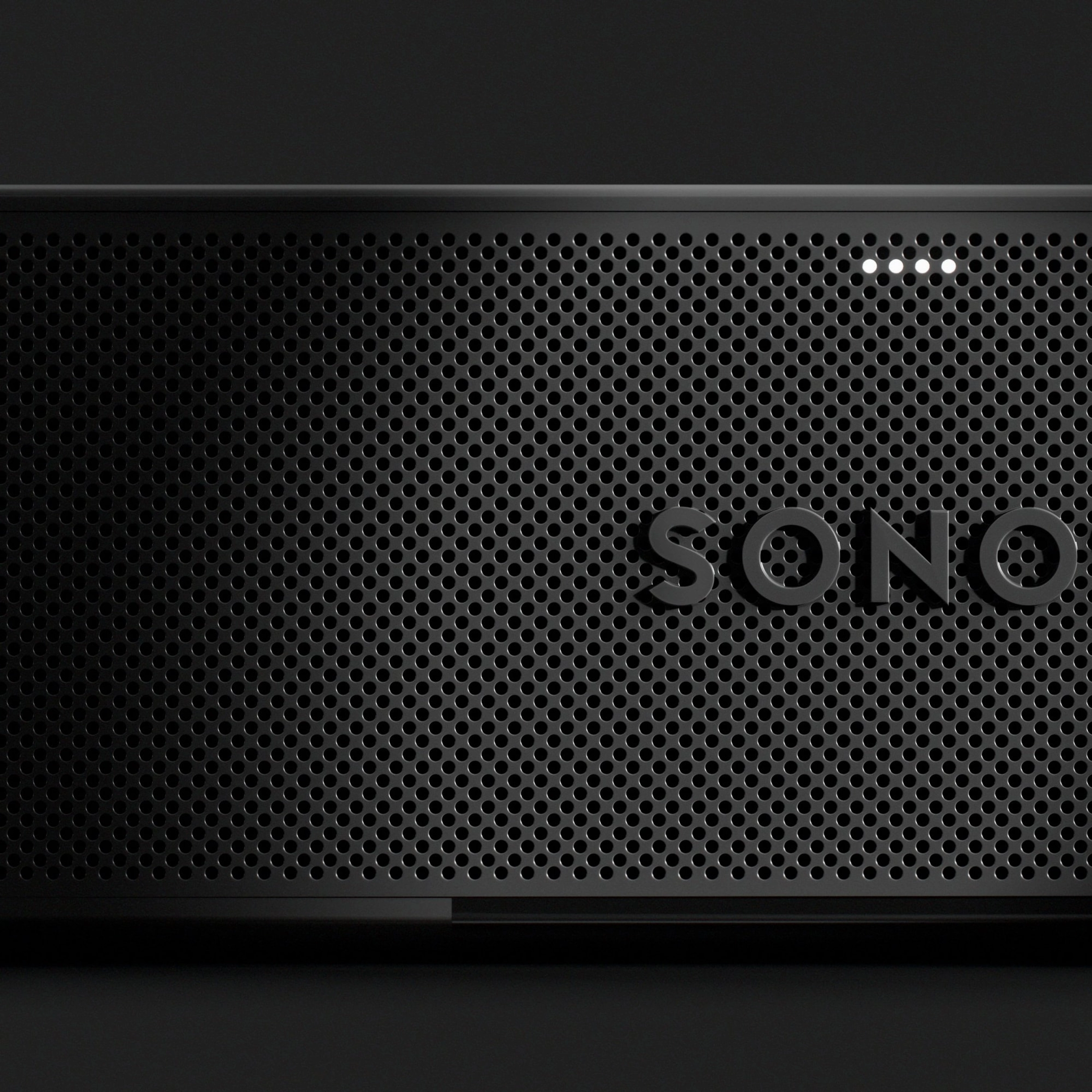 Close-up of the perforated grille and Sonos Beam Ultra logo in black
