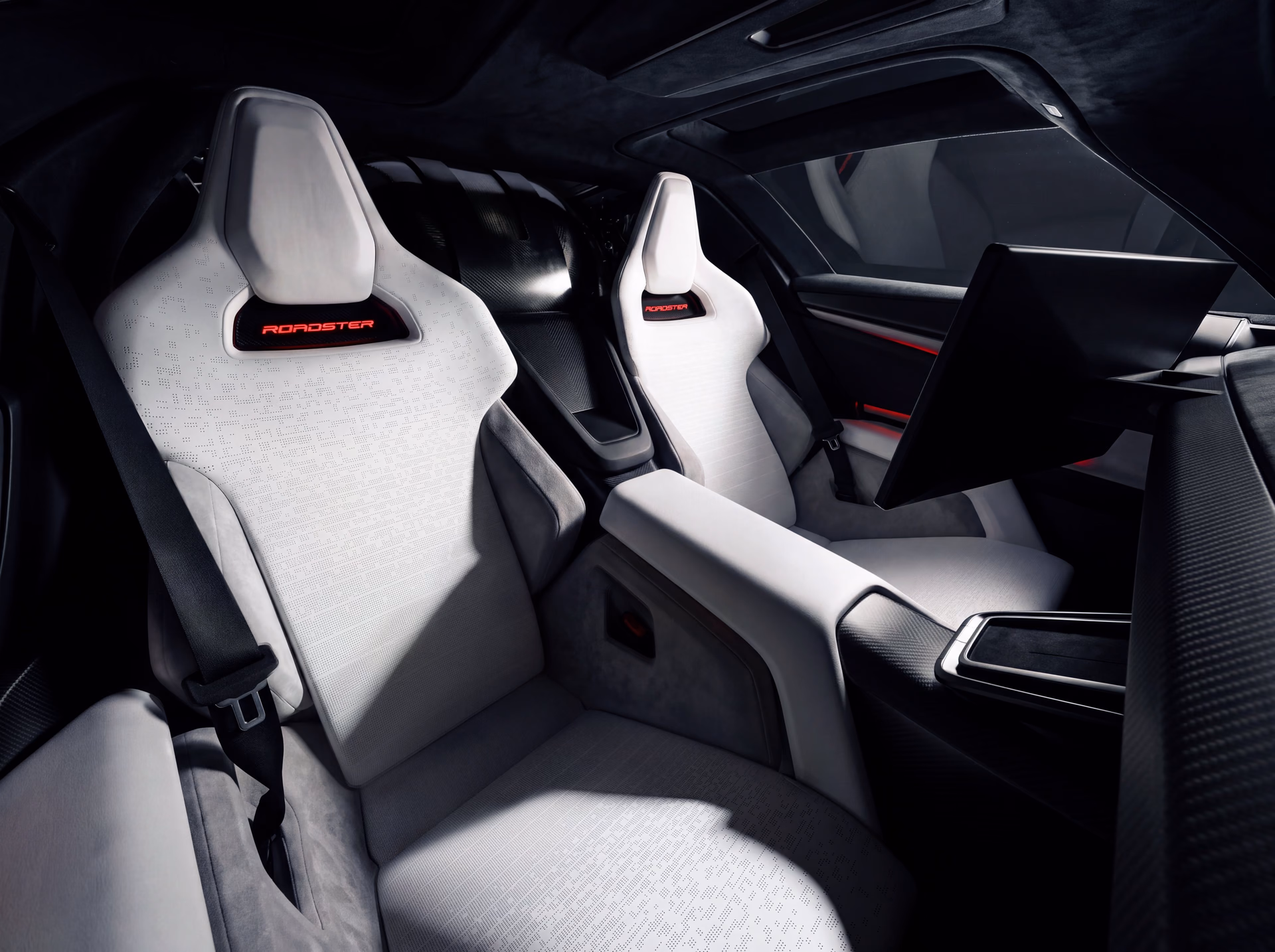 Two light-colored seats in the Tesla Roadster seen from the door