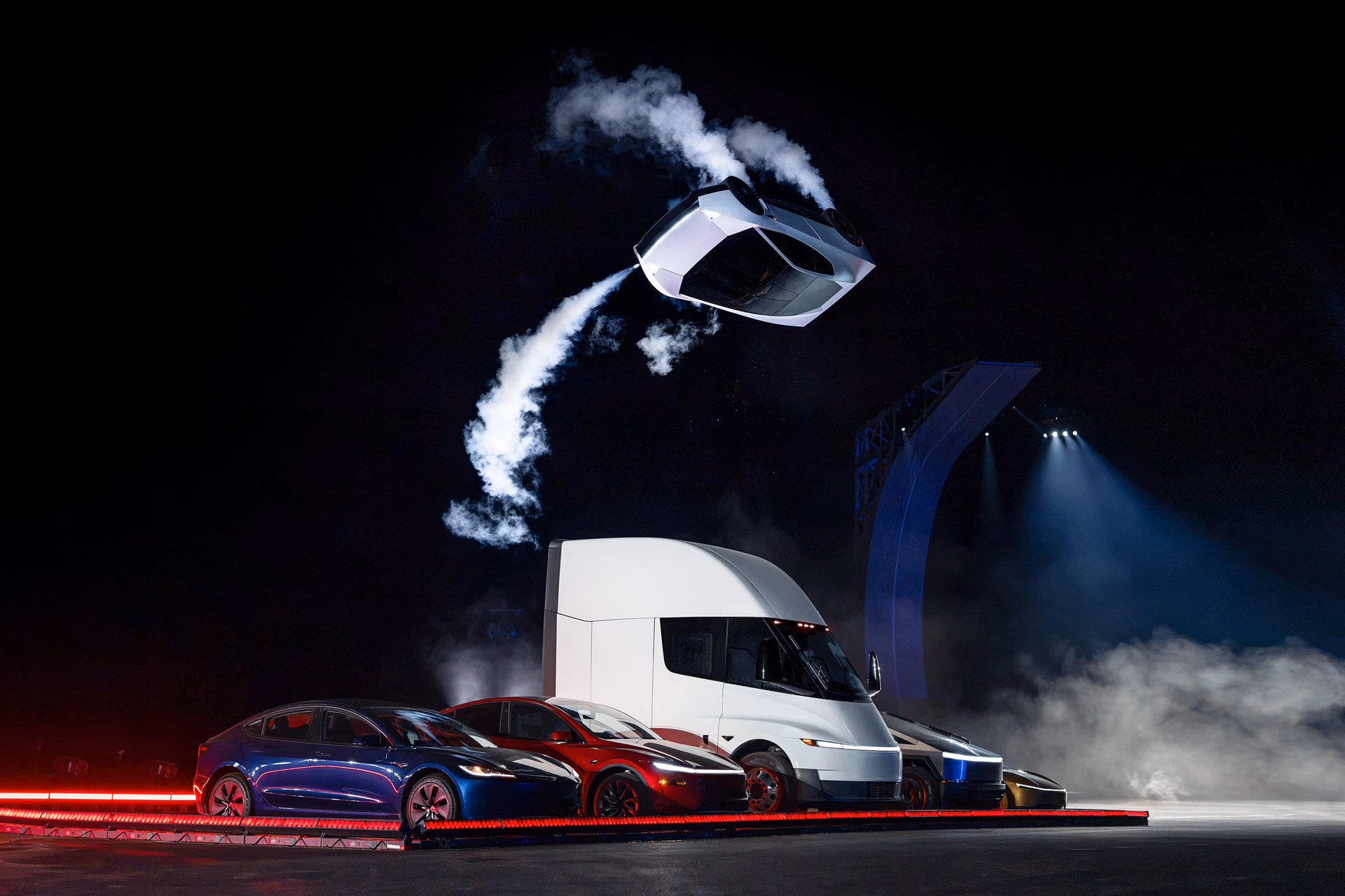 Roadster prototype rotating over a row of Tesla vehicles