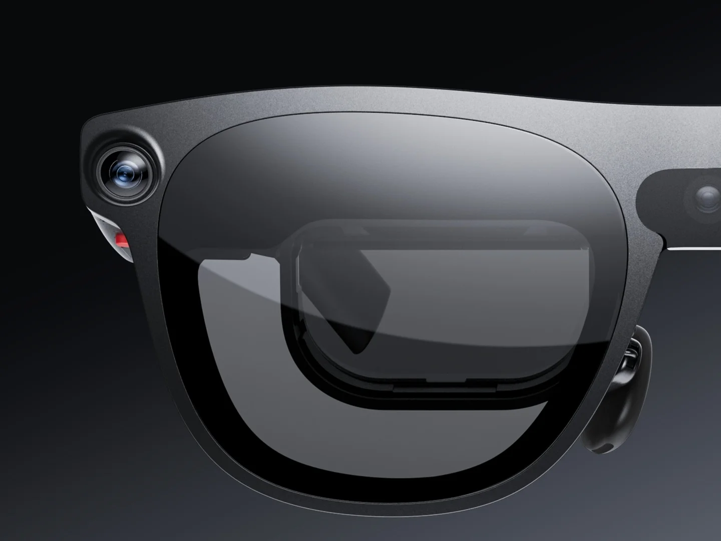 Primer plano frontal de las gafas XREAL Aura con sus cámaras y la óptica see-through dentro de la lente